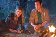 Caitlin Bassett as Addison, Raymond Lee as Dr. Ben Song sitting in front of a campfire