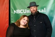 Chrissy Metz and Chris Sullivan posing next to each other at an event.