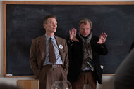 Cillian Murphy (as J. Robert Oppenheimer) and writer, director, and producer Christopher Nolan on the set of OPPENHEIMER.