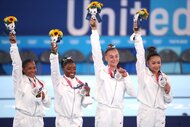 Jordan Chiles, Simone Biles, Grace. McCallum and Sunisa Lee holding up flowers and silver metals during the Team final for Women at Ariake Gymnastics Centre.