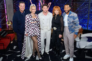 Carson Daly, Gwen Stefani, Niall Horan, Reba McEntire, and John Legend pose and smile together backstage of The Voice.