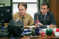 Rainn Wilson as Dwight Schrute and Steve Carell as Michael Scott sit at a computer together