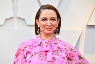 Maya Rudolph, wearing a pink floral dress while smiling at the camera, attends the 91st Annual Academy Awards.