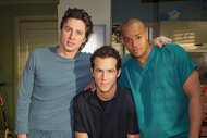 Dr. John Dorian, Spence, and Dr. Christopher Turk posing together on the set of Scrubs.