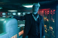 Cormac (Mel Gibson) stands in a control room