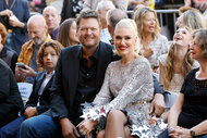 Blake Shelton and Gwen Stefani sit together during her Hollywood Walk of Fame Star Ceremony