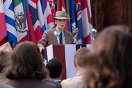 J. Robert Oppenheimer stands at a podium in Oppenheimer