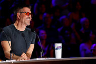 Simon Cowell smiles in his judges chair on America's Got Talent: Fantasy League Episode 101