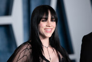 Billie Eilish smiles on the red carpet at the Vanity Fair Oscar Party