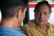 Pierre talks to Thomas Magnum in a car on Season 5 Episode 17 of Magnum P.I