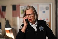Trudy Platt speaks on a cellphone while in police uniform in Chicago P.D. Episode 1102