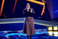 Mafe sings in a skirt in Season 25 Episode 4 of The Voice.