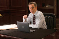 Da Nicholas Baxter sits at his desk on Law And Order Episode 2307
