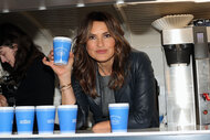 Mariska Hargitay holds up a 'Benson and Co.' coffee cup