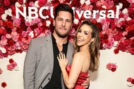 Scheana Shay and Brock Davies embrace and pose together in front of a flower wall