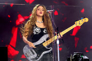 Shakira plays guitar while performing at TSX In Times Square
