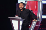 John Legend smiles at a performer