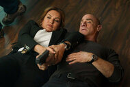 Olivia Benson and Elliot Stabler scramble on the floor in Law & Order: Organized Crime Season 3 Episode 22.