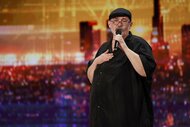 Richard Goodall sings on stage during AGT Episode 1901.