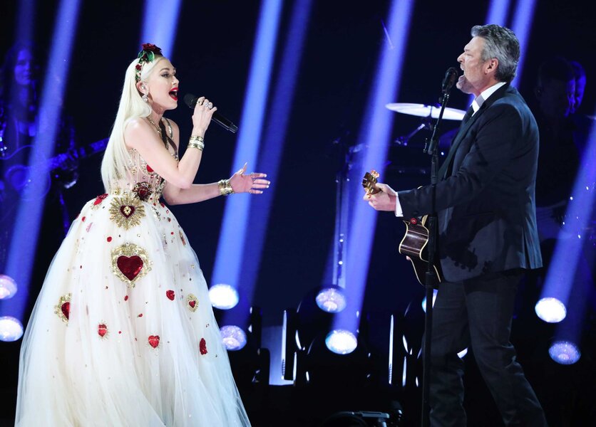 Gwen Stefani and Blake Shelton performing together on stage.