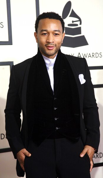 John Legend posing on the 50th Grammy Awards red carpet.