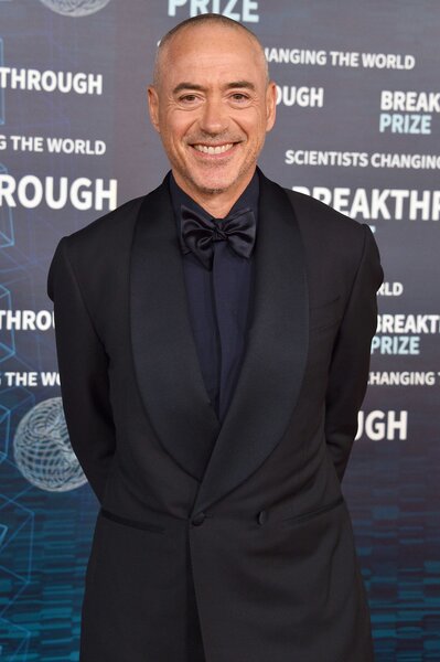 Robert Downey Jr. attends an event wearing an all black suit.