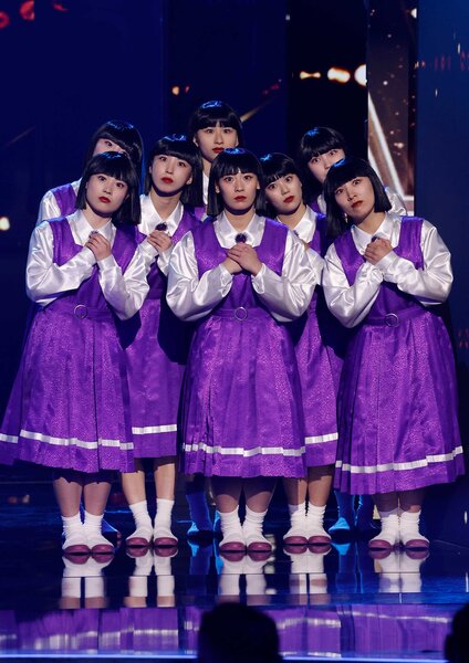 Avantgardey wearing purple dresses and huddled together on stage during the results of America's Got Talent.