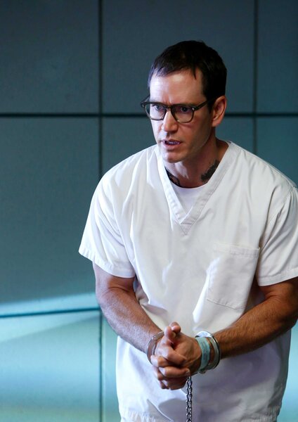 Paul Winthrop appears in all white attire with his hands tied during a scene from CSI.
