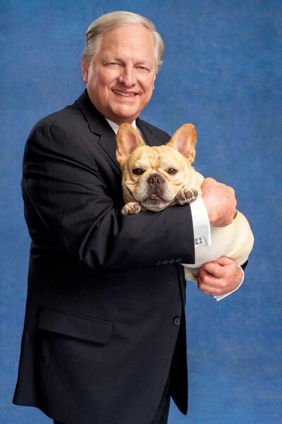 David Frei posing and hugging Winston, the French Bulldog, for The National Dog Show.