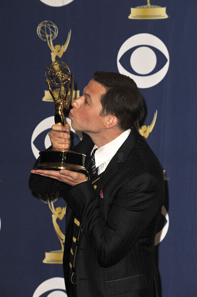 John Cryer kisses an Emmy Award trophy at the 61st Primetime Emmy Awards