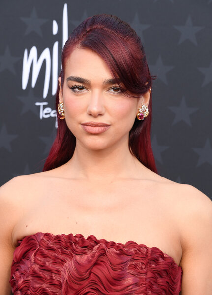 Dua Lipa stuns in red hair and a matching red dress.