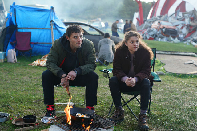 Lucas and Veronica sitting in front of a fire