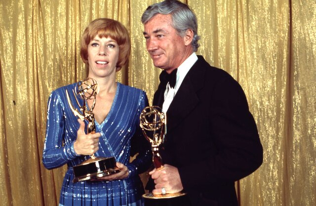 Carol Burnett and Joe Hamilton holding their Emmy Awards.