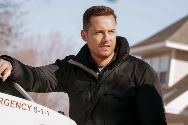 Jesse Lee Soffer standing next to an emergency vehicle on Chicago P.D.