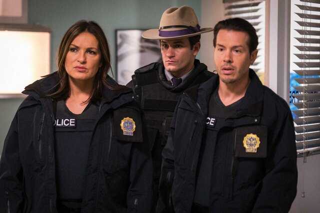 Jon Seda as Detective Antonio Dawson standing next to Mariska Hargitay as Lieutenant Olivia Benson and Kevin Kane as Major Bowman on the set of Law & Order.