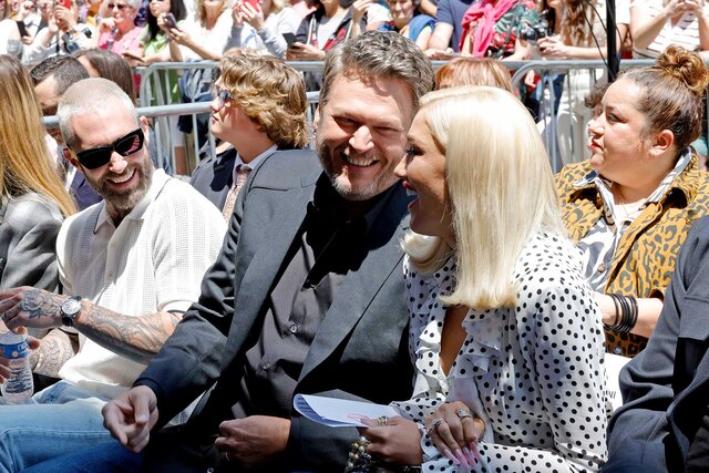 Adam Levine, Blake Shelton and Gwen Stefani sitting together at Blake Shelton's The Hollywood Walk Of Fame Ceremony.