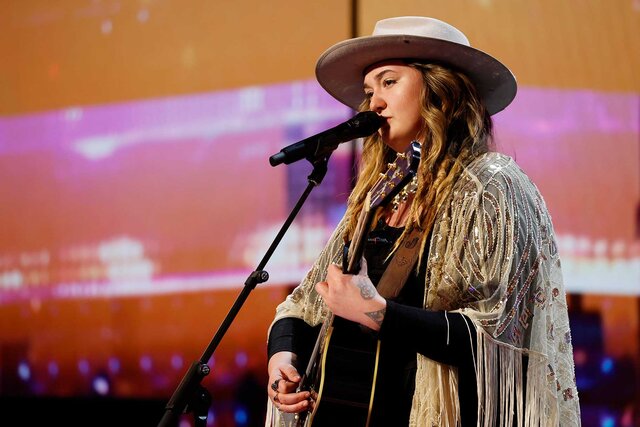 Dani Kerr playing guitar and singing on America's Got Talent.