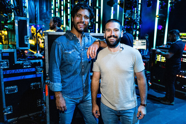 Dan Smyers and Shay Mooney smiling and posing backstage during night 1 of the 50th CMA Fest