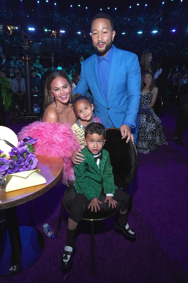 Chrissy Teigen, Luna Stephens, Miles Stephens, and John Legend posing at the Grammy Awards.