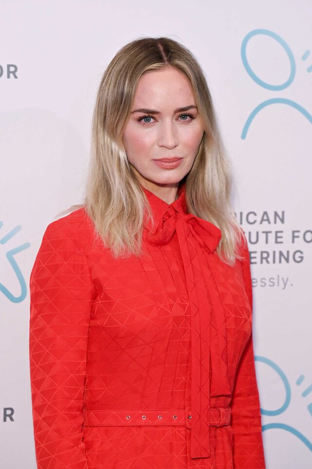 Emily Blunt attends an event wearing a red dress.