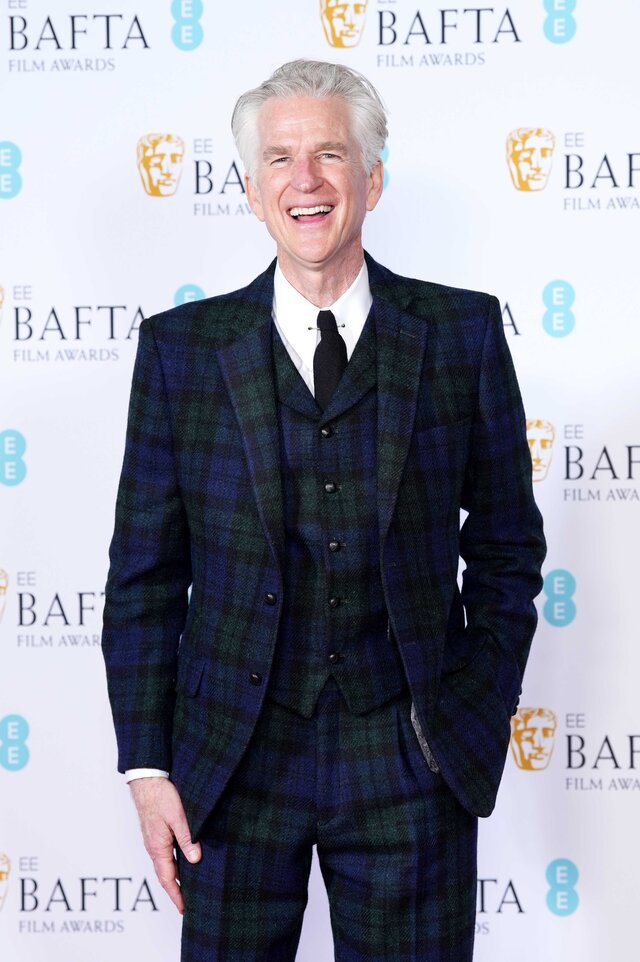 Matthew Modine attends an event wearing a navy and green plaid suit.