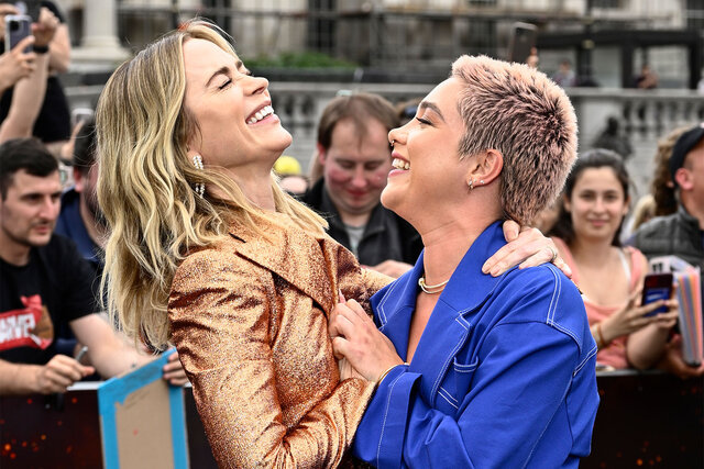 Emily Blunt and Florence Pugh laugh while attending a photocall for "Oppenheimer" at Trafalgar Square on July 12, 2023