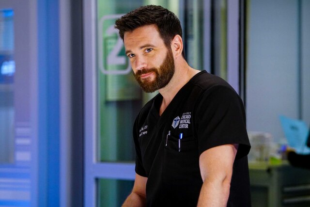 Dr. Connor Rhodes wearing black scrubs in a scene from Chicago Med.