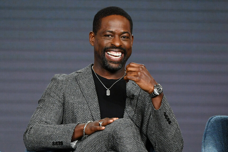 Sterling K Brown smiling while seated