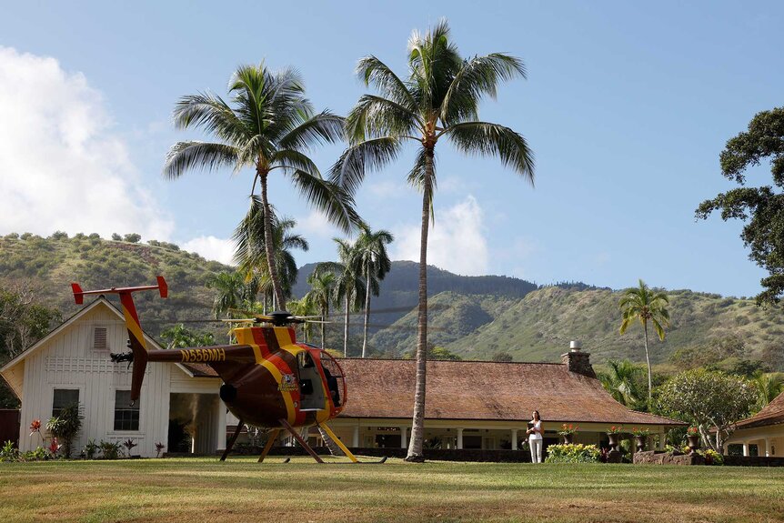 A helicopter lands in front of Magnum's house