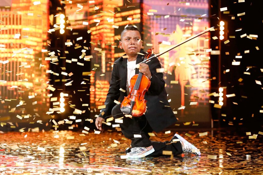 Tyler Butler Figueroa surrounded by gold confetti on America's Got Talent.