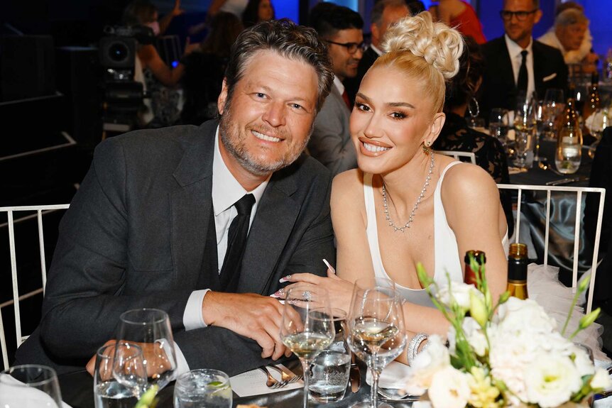 Blake Shelton and Gwen Stefani posing together during an event.