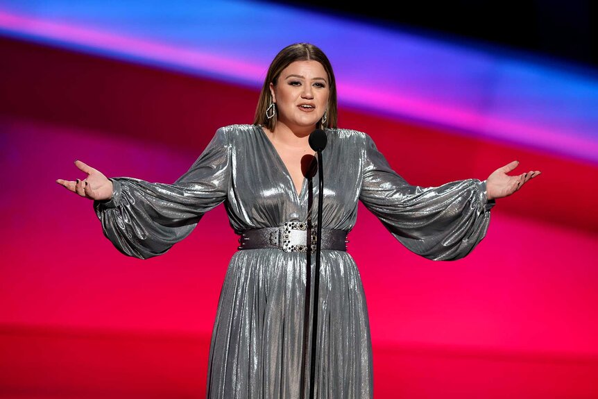 Kelly Clarkson presenting on stage at the NFL Honors show.