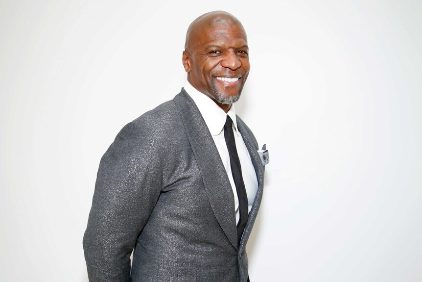 Terry Crews posing and smiling.