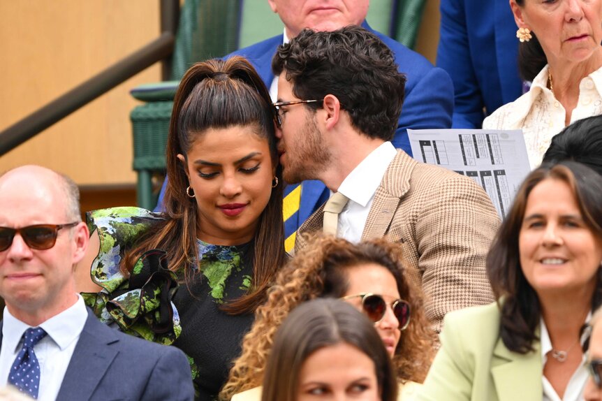 Nick Jonas giving Priyanka Chopra a kiss on the cheek.